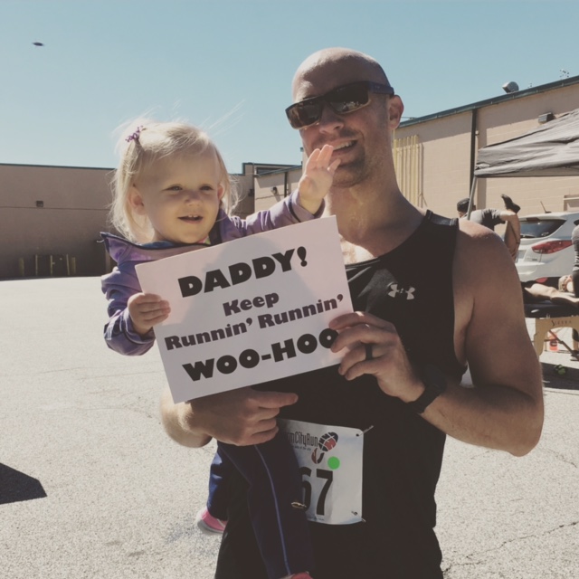 Bobby poses with daughter Ryan and her festive sign.