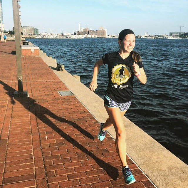 Katie runs around the Inner Harbor during a fun run from the Baltimore store